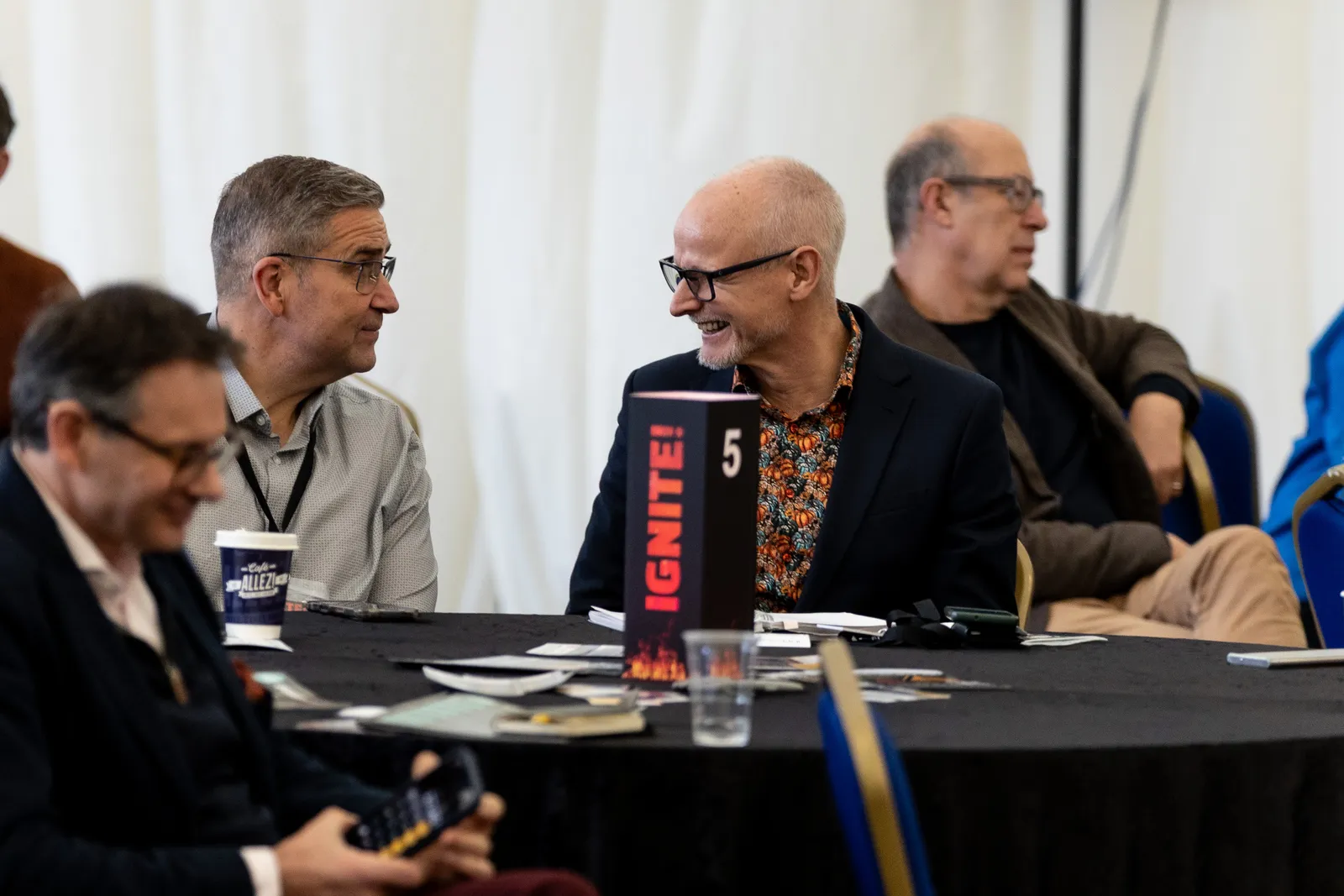 Delegates comparing notes between agenda slots at IGNITE! 26