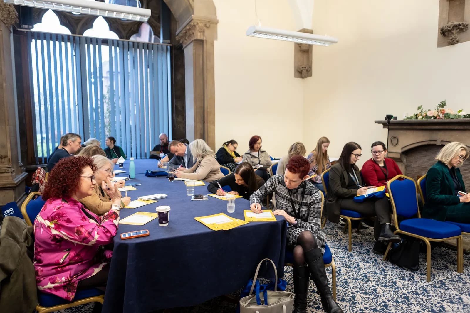High-ceilinged interior at Kelham Hall with delegates in conversation